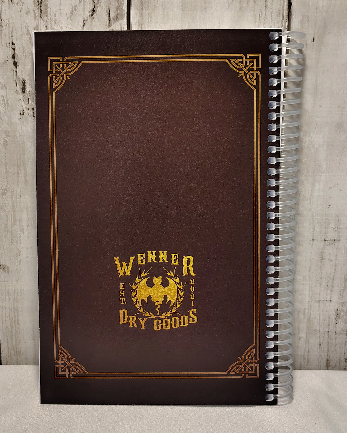 Back view of the Dungeon Designer's Notebook: a compact, spiralbound notebook for TTRPG Dungeon Masters to design dungeons and more.