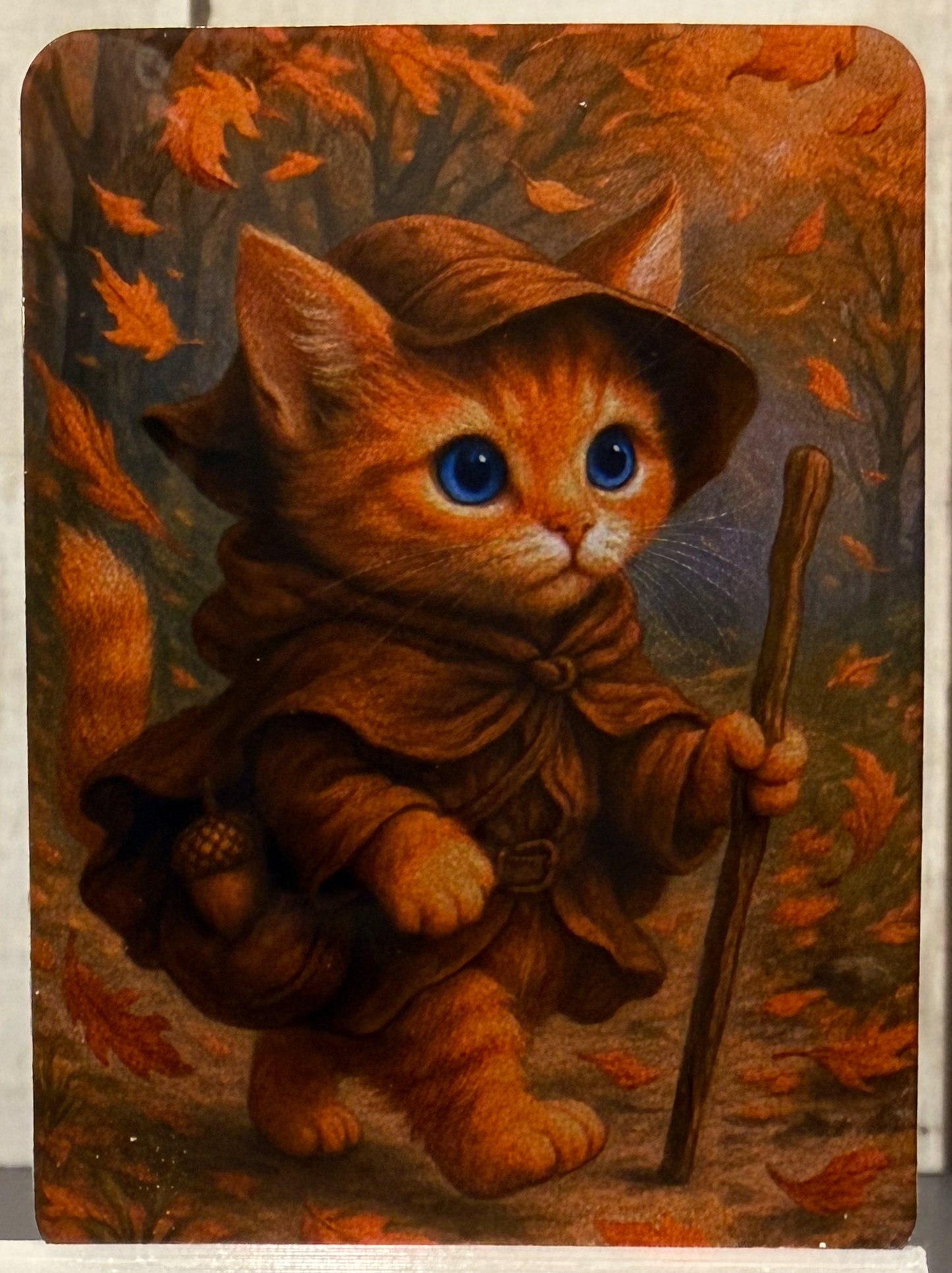Magnet featuring an adventurer kitty in the forest during autumn, surrounded by falling leaves