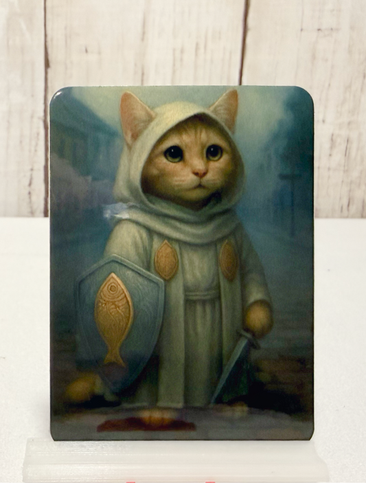 Magnet featuring a cleric cat in a hooded outfit with a shield and sword