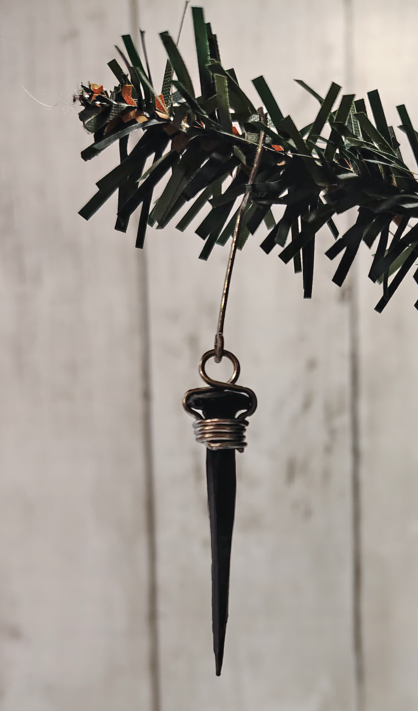 Black coffin nail ornament, hand-wrapped in 18-gauge aluminum wire