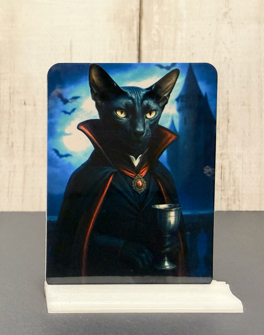 Magnet featuring a vampire cat in a cape holding a chalice against a mystical background