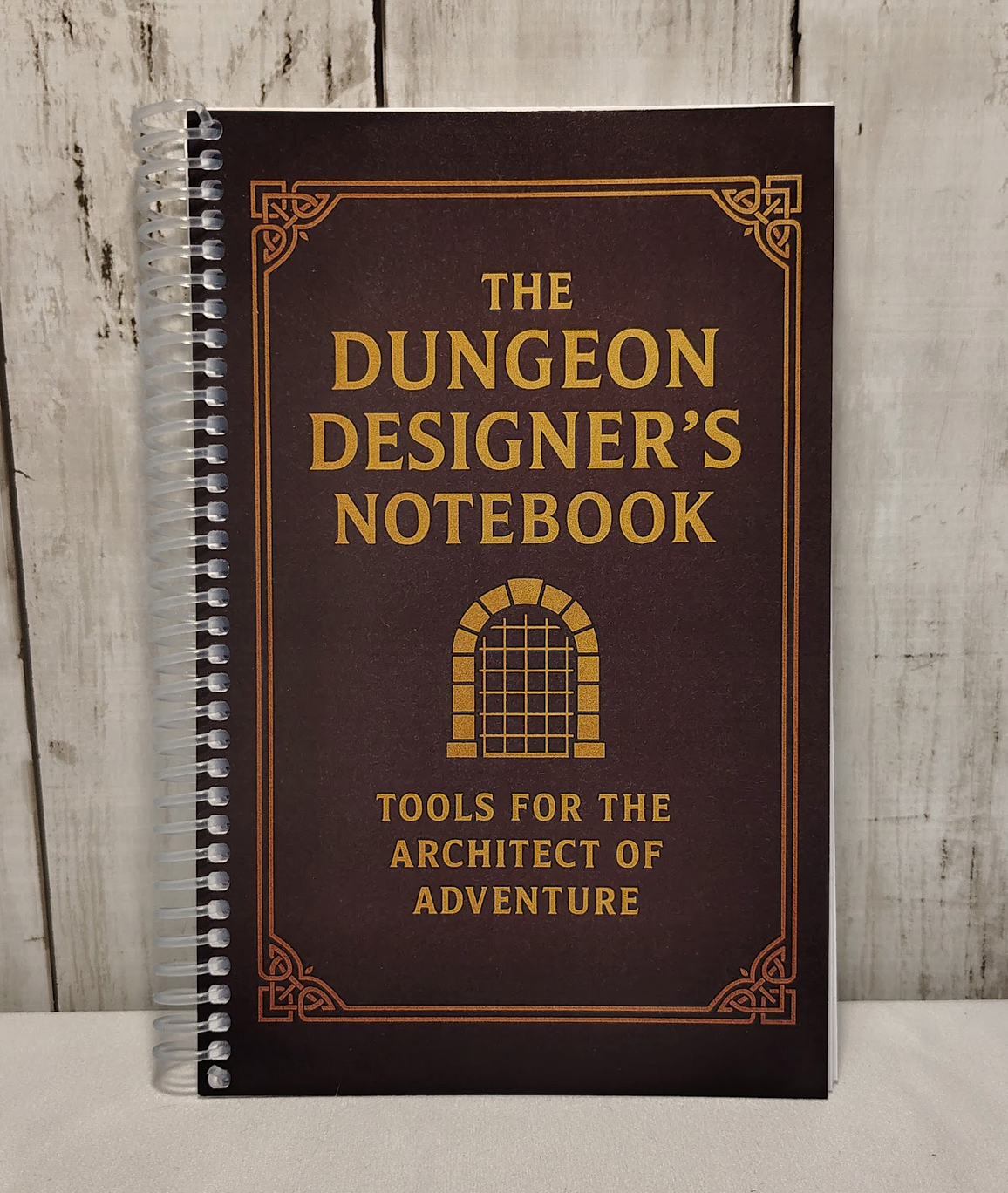 Front view of the Dungeon Designer's Notebook: a compact, spiralbound notebook for TTRPG Dungeon Masters to design dungeons and more.