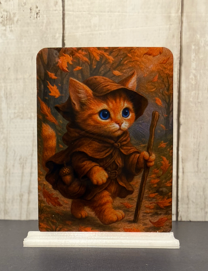 Magnet featuring an adventurer kitty in the forest during autumn, surrounded by falling leaves