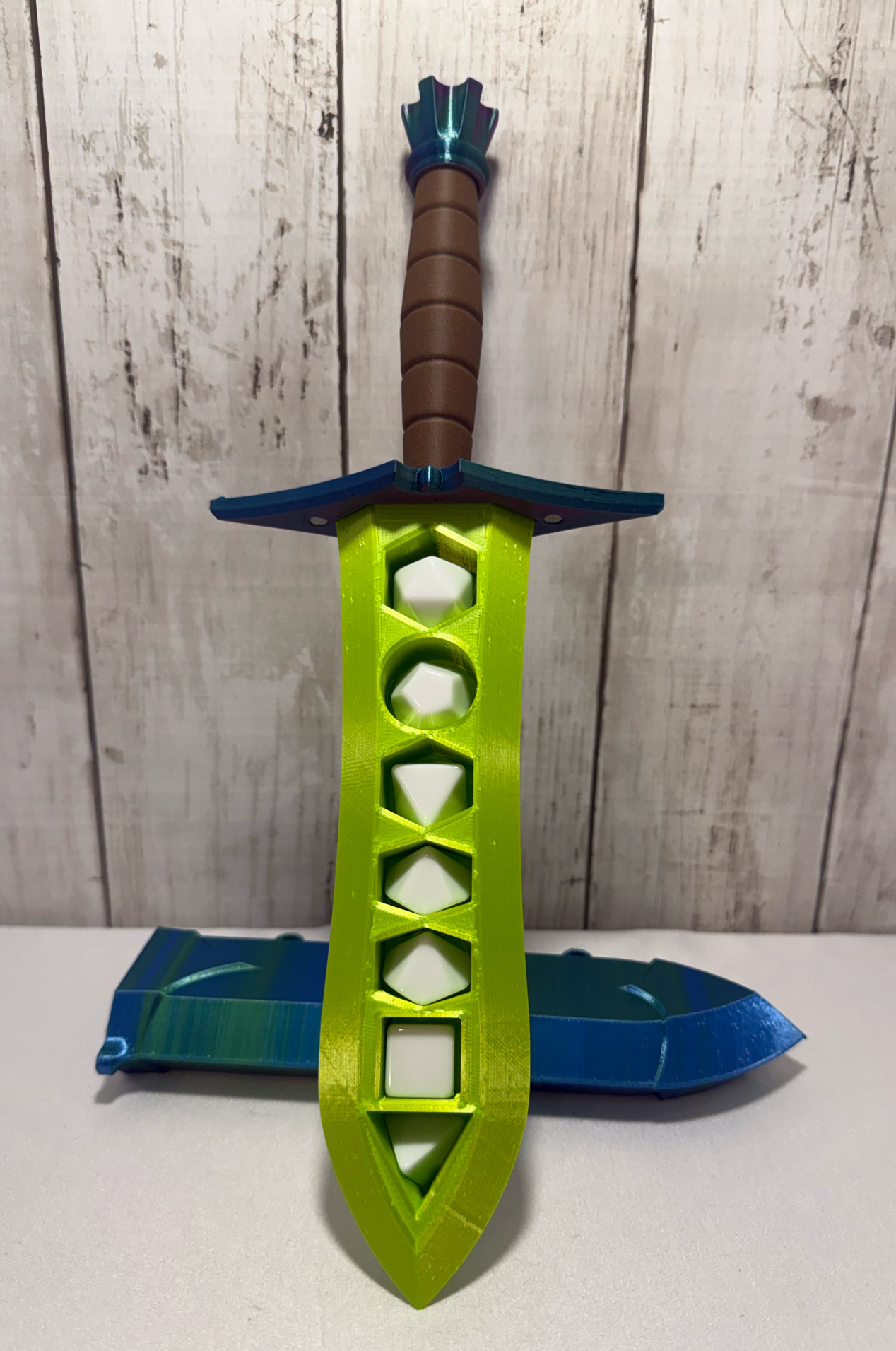 3D-printed dice sword with neon green blade, green pommel, brown handle, and matching sheath.