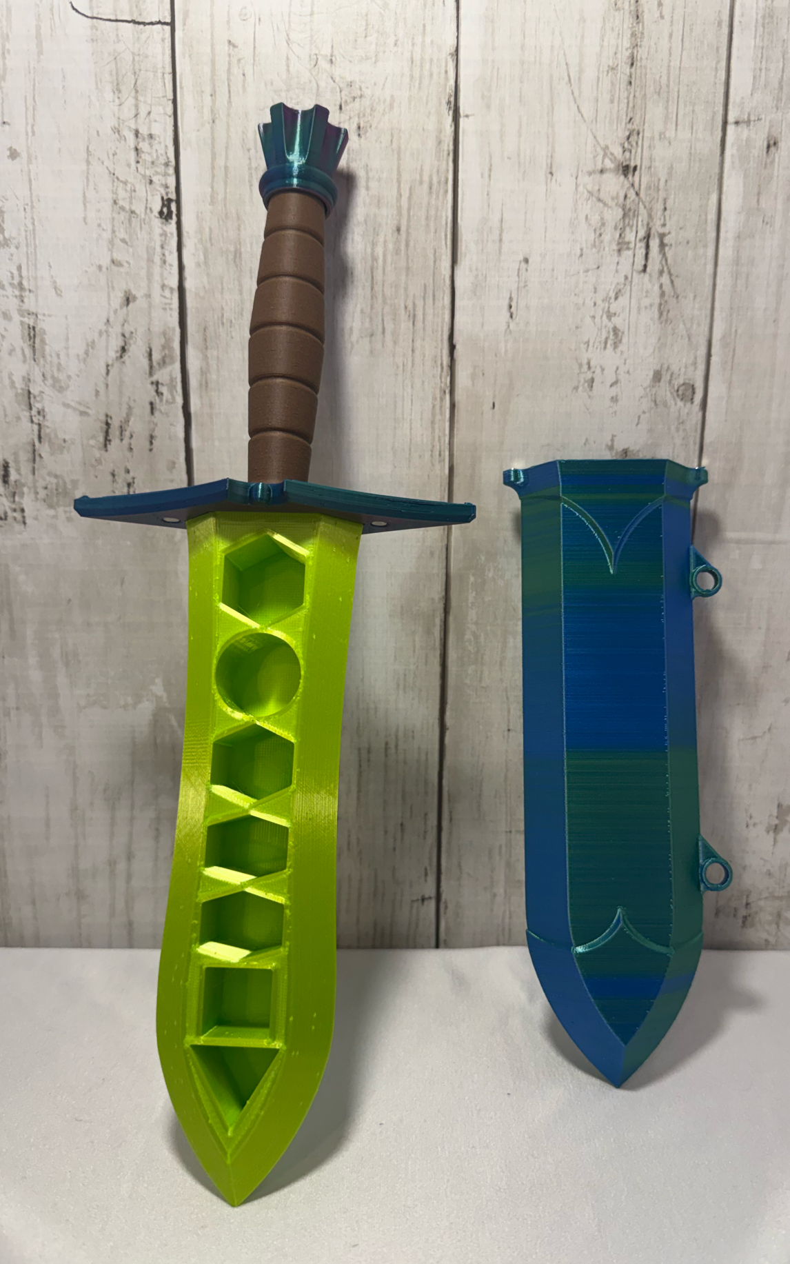 3D-printed dice sword with neon green blade, green pommel, brown handle, and matching sheath.
