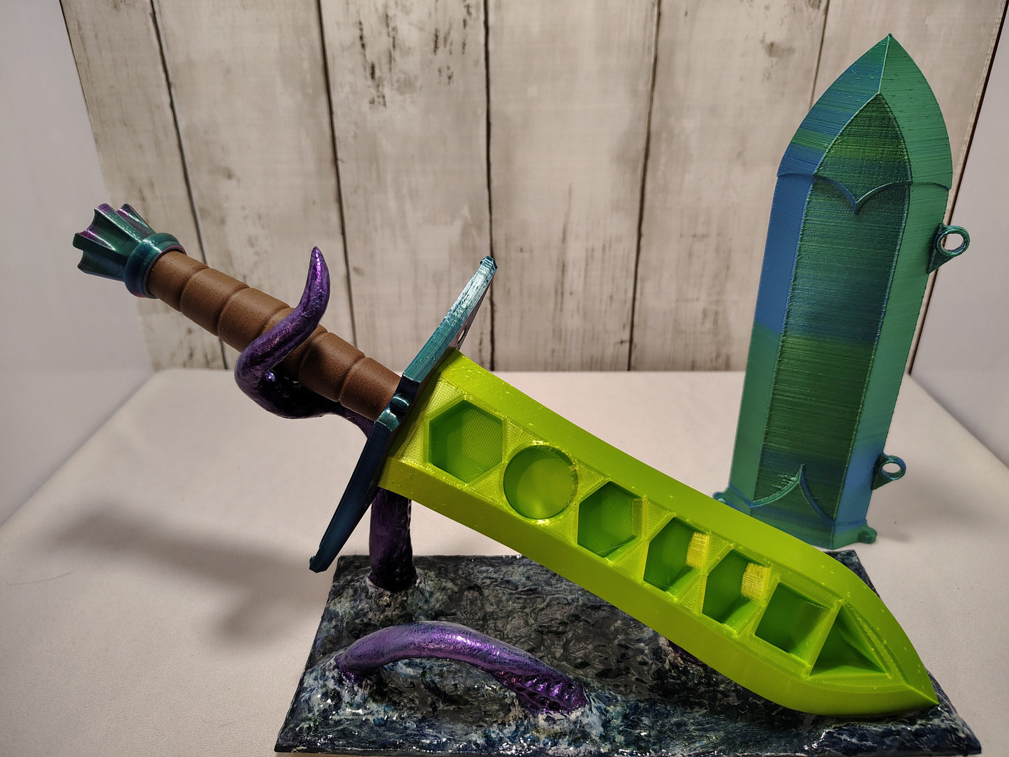 3D-printed dice sword with neon green blade, green pommel, brown handle, and matching sheath.