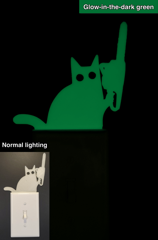 Glowplate light switch finder: glow-in-the-dark green cat with chainsaw, shown in normal lighting and glow-in-the-dark conditions.