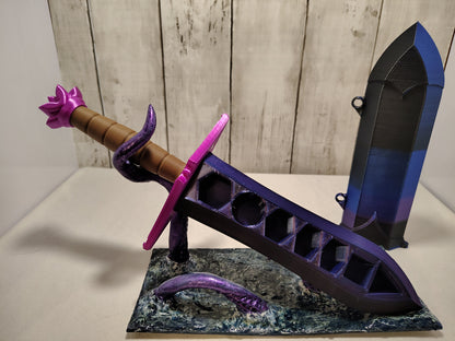 3D-printed dice sword with purple blade, pink pommel, brown handle, and matching sheath.