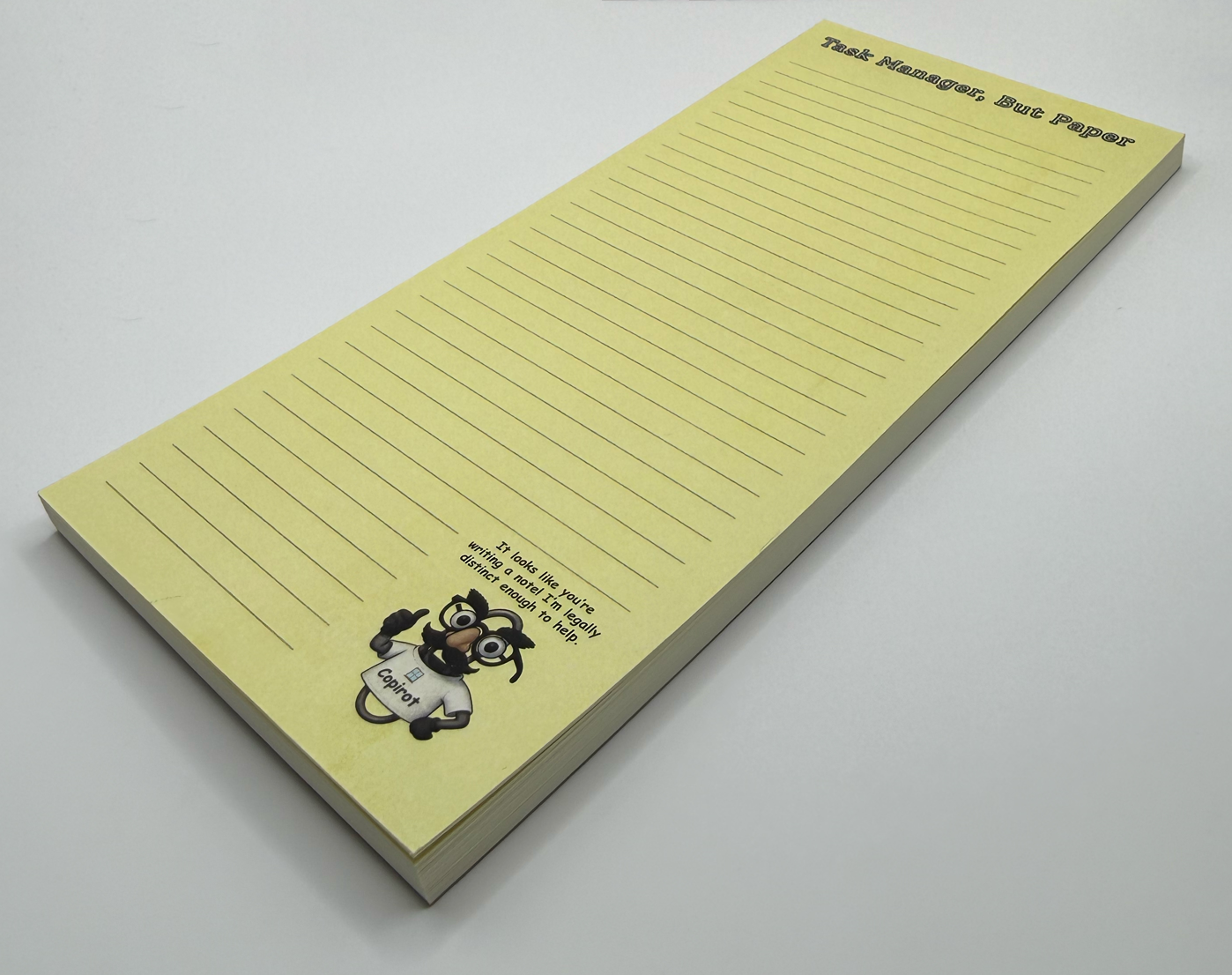 Side view: Task Manager, But Paper lined notepad